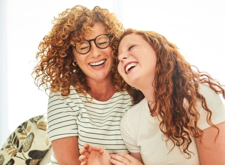 img-mother-and-daughter-on-cauch-laughing-1200x630px.jpg