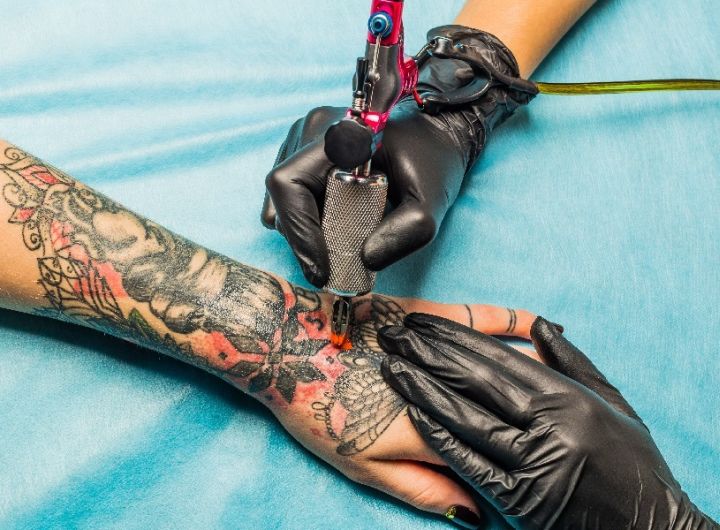 large tattoo being done on forearm